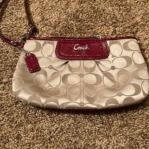 COACH WRISTLET. It is in very good condition except the zipper pull is missing.